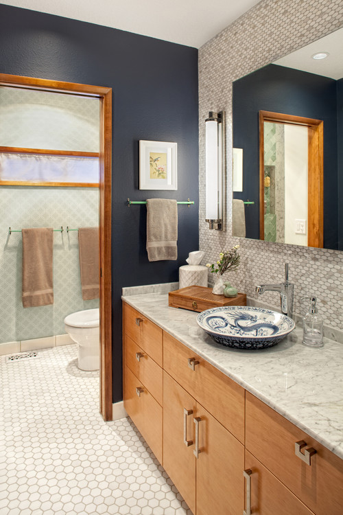 navy walls paired with marble penny tiles create a chic and bold modern look, light-colored wood adds coziness