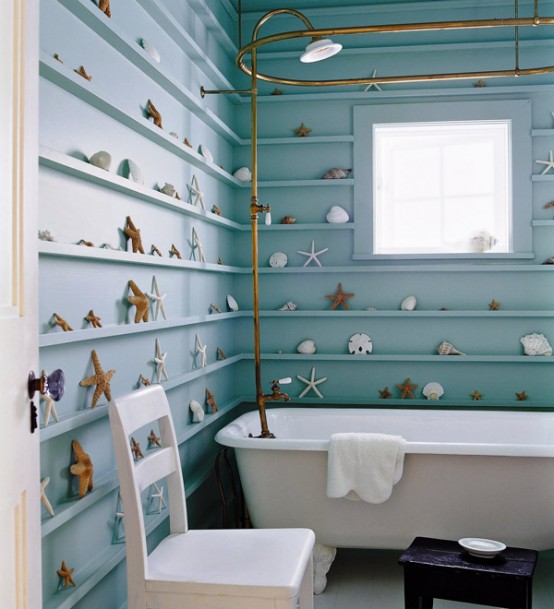 turquoise walls with ledges to display various seashells and starfish and white furniture and a tub
