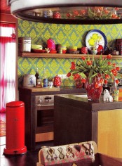 a colorful kitchen with boho touches – brown furniture, printed wallpaper, touches of red and boho prints looks unusual