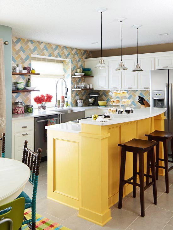 a bright kitchen with white cabinetry, a colorful tile backsplash and a bold yellow kitchen island is a fun and cool space with a beachy feel