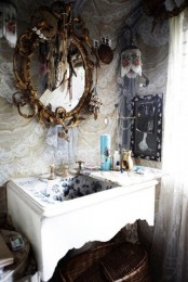 a refined bathroom with lace curtains, a carved wooden vanity, an ornate mirror and macrame hangings