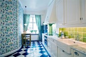 a colorful kitchen with white vintage cabinetry, blue and green tiles, cool floral wallpaper, plaid green curtains is a fun and cool space