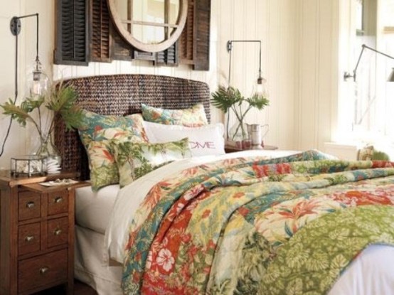 a tropical bedroom with dark stained shutters on the wall, a wicker bed, tropical bedding and palm fronds