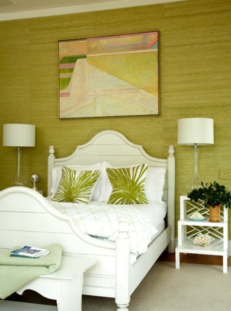 A pistachio statement wall, tropical print pillows and vitnage inspried white furniture add a tropical feel to the space
