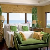 wicker shades, tropical print textiles, a driftwood base lamp and an antique wooden nightstand