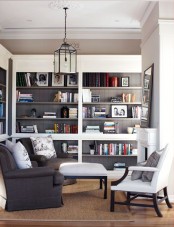 a neutral living room with built-in bookshelves on two walls by the fireplace is a very stylish and cool idea