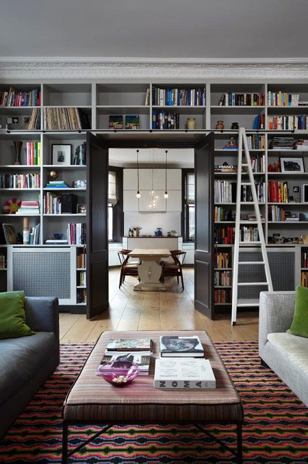 a whole wall taken by built-in shelves will turn your living room or any other room into a library