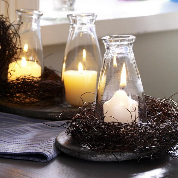 Bottles with pillar candles wrapped with vine and on trays are amazing for styling your space for Thanksgiving in a rustic way