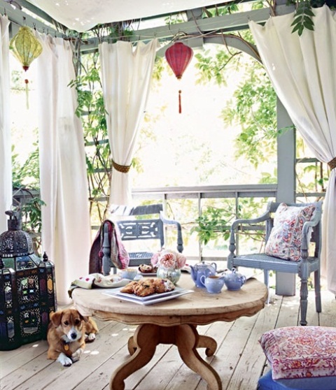 a fresh space with carved vintage wooden furniture, a large Moroccan lantern and bright printed textiles