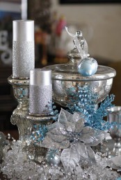 refined silver and blue Christmas decor with beads, silver candles in candleholders, blue branches and ornaments is very refined
