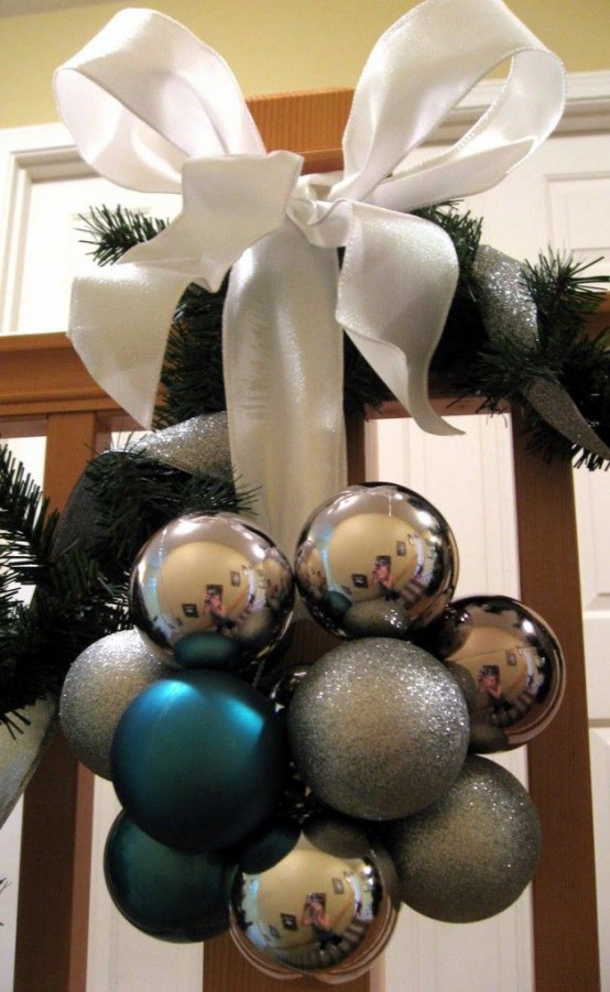 a lovely Christmas decoration of silver, grey and blue ornaments, a large white ribbon bow can be used both inside and outside