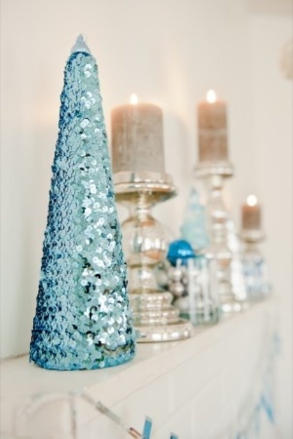 a tiffany blue sequin Christmas tree on the mantel is a cool and sweet decoration to rock