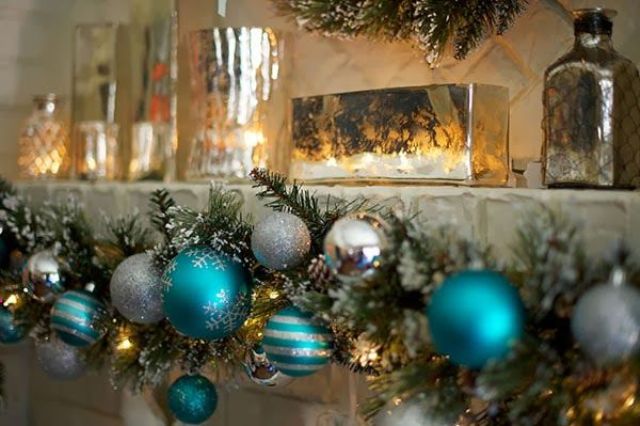 A garland with silver and tiffany blue ornaments and lights is a pretty decoration for indoors and outdoors