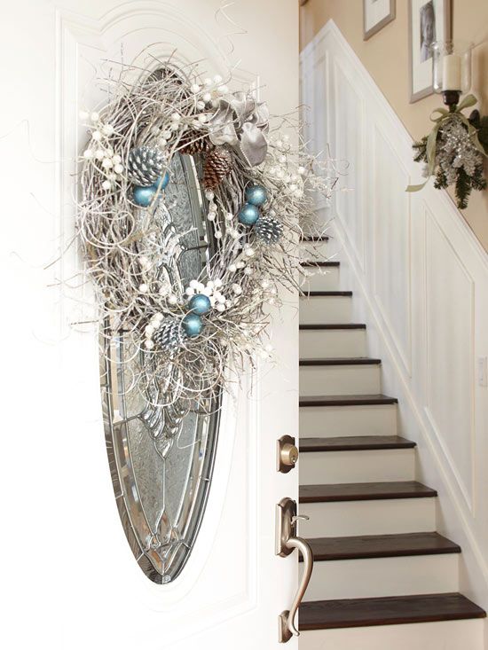 a frozen Christmas wreath with pinecones, ornaments and feathers, a ribbon bow and beads is a lovely decoration