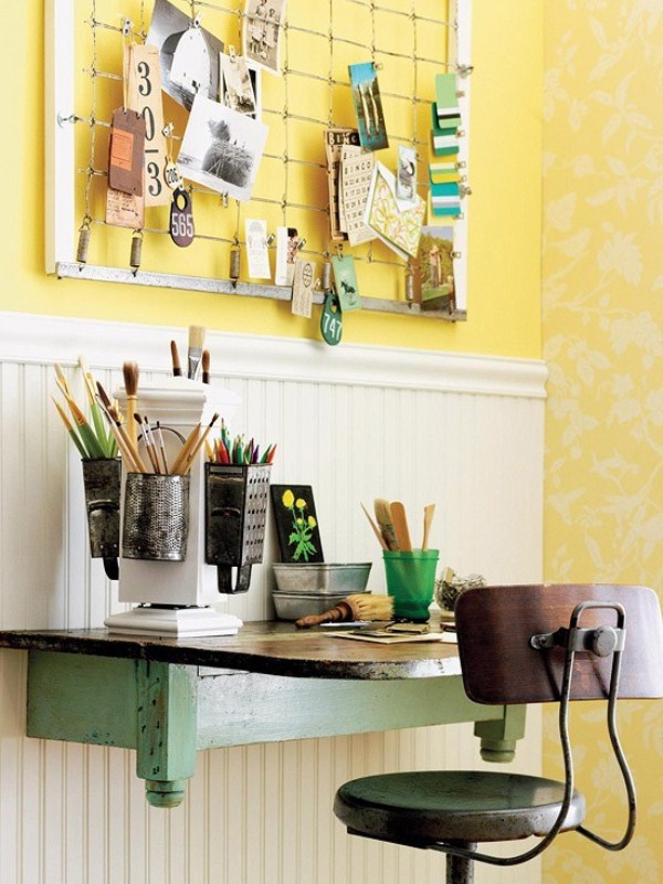 A bright vintage home office with wall paneling, a green wall mounted desk, a vintage industrial chair and a memo board with notes is a lovely nook