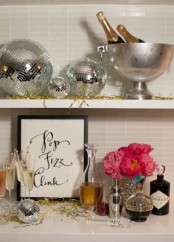 silver disco balls and bold pink blooms plus gold tinsel will make your NYE party fun, bold and cool