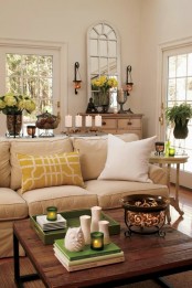 potted blooms, greenery, touches of yellow and green bring a cheerful summer feel to the living room