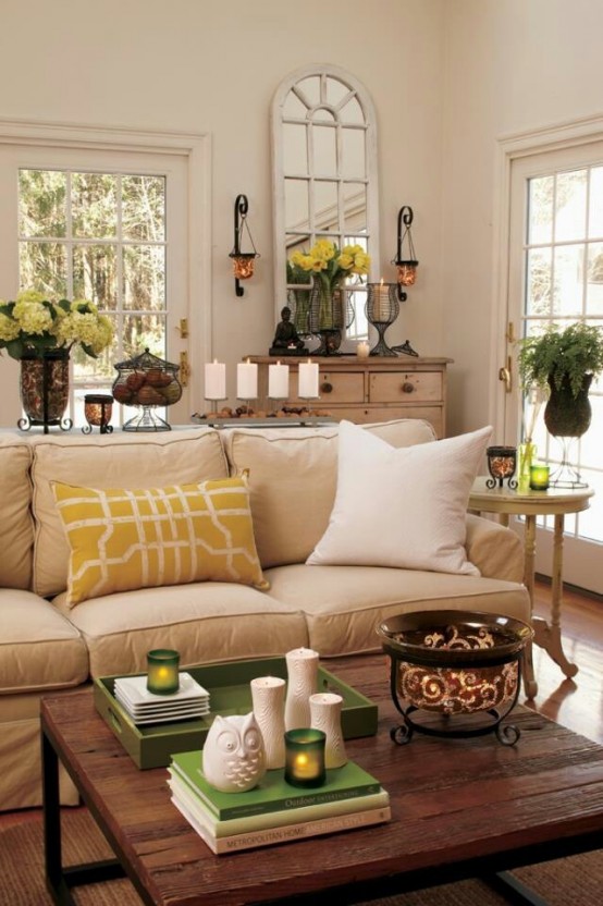 potted blooms, greenery, touches of yellow and green bring a cheerful summer feel to the living room