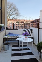 a stylish small balcony decorated in Scandinavian style