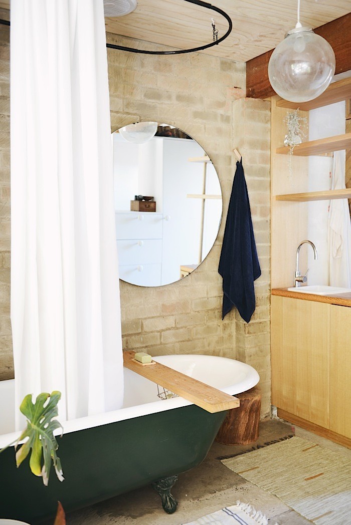 Chic Brick Bathroom With A Retro Green Bathtub