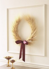 an artwork of a wheat wreath accented with a purple bow is a cool idea for natural and rustic fall decor