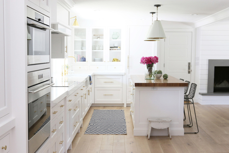 Chic white kitchen remodel with brass touches  1