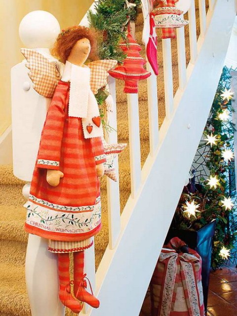 Evergreen swags with red accents looks wonderful on any white staircase.