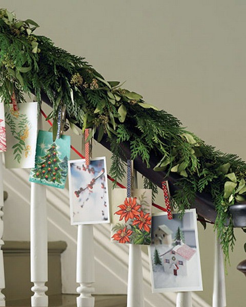 To dress your staircase for the holiday season, upgrade a garland of evergreen with beautiful seasonal pictures.