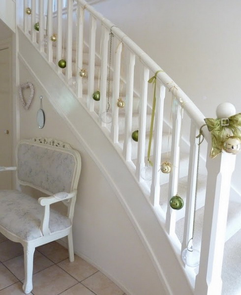 Don't like Greens? Say goodbye to them and simply hang a bunch of ornaments on your staircase's railing.