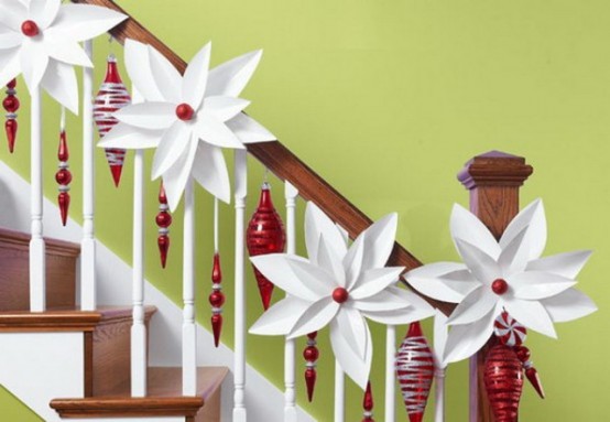 The mix of white snowflakes and red ornaments look very chic and cool on the white guardrails.