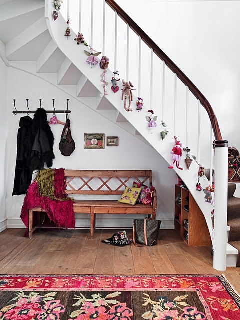Kids toys is a great alternative to ornaments to hang not only on a Christmas tree but on a staircase too.