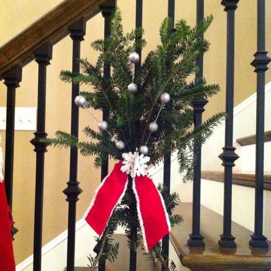 Instead of swags of greenery trailing down the banister, try these evergreen bunches. Use florist's wire or ribbon to lash them to the banister posts.