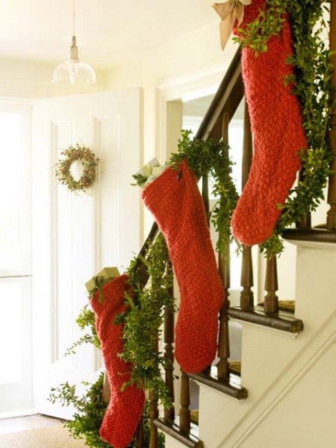 Add to the traditional staircase evergreen swag some Christmas stockings in seasonal colors.