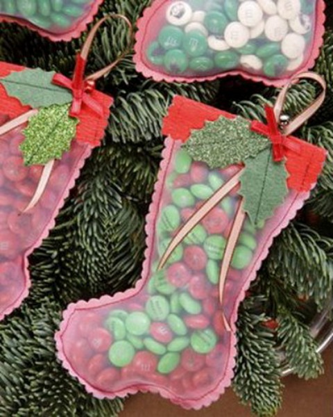 red semi sheer stockings with fabric leaves and berries and with candies inside make great Christmas favors that won't break the bank