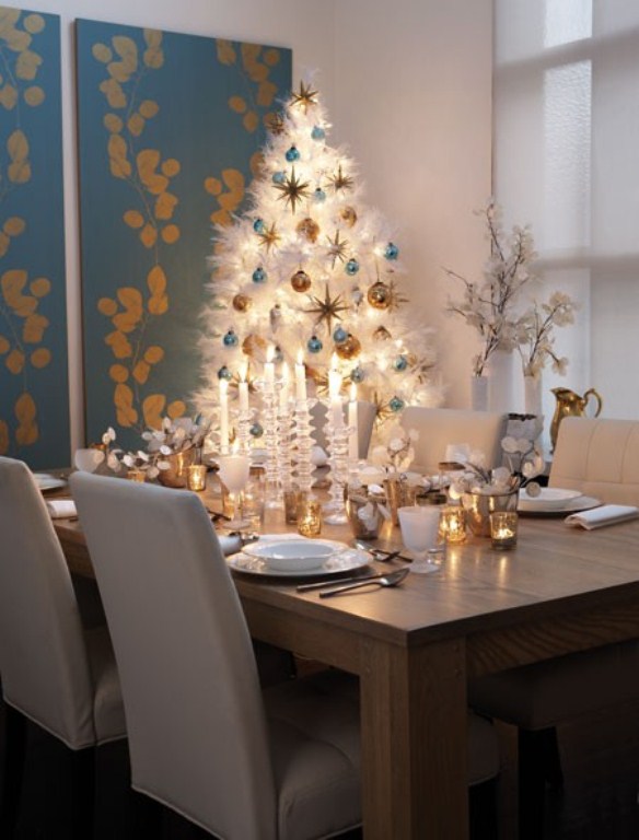 a white Christmas tree with blue and gold ornaments and lights is a very chic and bold idea for Christmas
