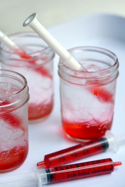 Jars with bloody syringes for decorating your Halloween party   make them yourself