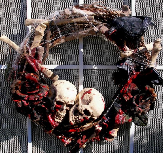 a dark Halloween wreath with black bloody roses, bones, skulls and spiderwebs