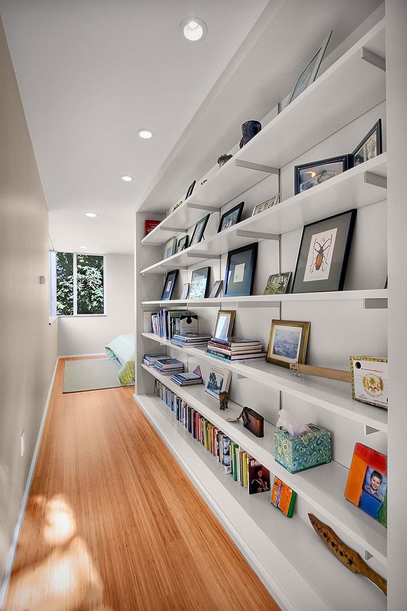 Open shelving works well in hallways because it usually doesn't occupy lots of space and isn't bulky. It's perfect to display family photos, stuff you bring from travels and books.