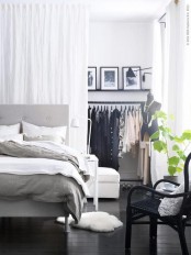 a makeshift closet hidden with a large white curtain  – you get two airy spaces that can be separated with a curtain or merged anytime