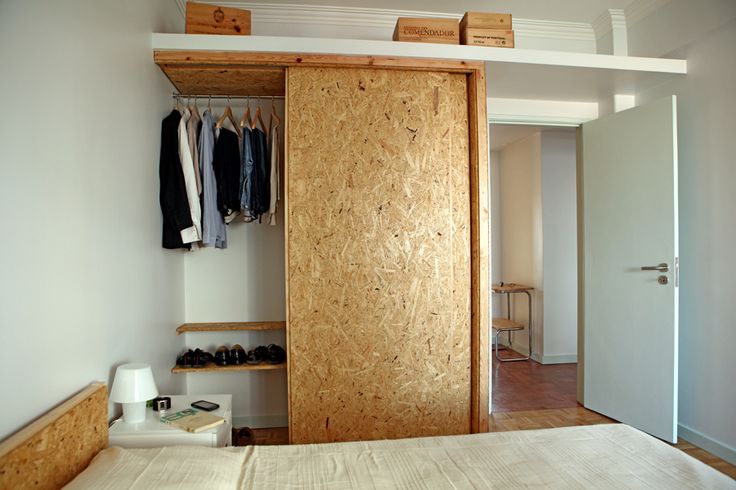 A small wardrobe with a sliding door and an additional open shelf over it is a cool idea for a modern and neutral bedroom, it doesn't take much space