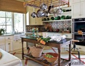 a bright tile backsplash and yellow cabinets plus some vintage furniture