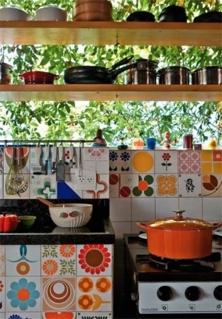 colorful mismatching tiles make the backsplash bold and the cabinet, too
