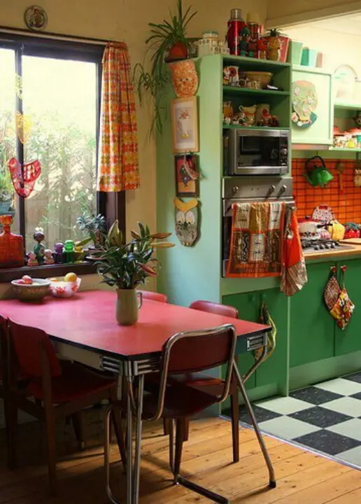 Green cabinets and a red table, vintage furniture and textiles for a bright retro inspired space