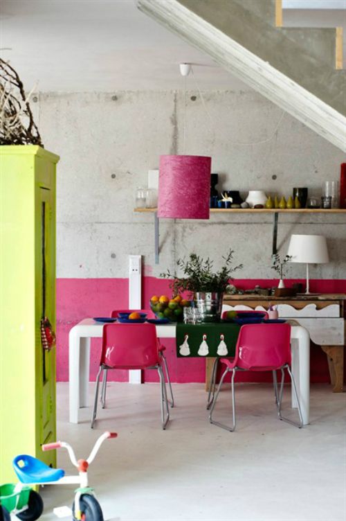 a minimalist meets boho chic kitchen with much concrete and touches of neon pink and yellow