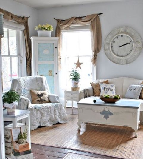Shabby chic furniture surrounds a vintage coffee table that looks like a chest. An antique clock and cool draperies also add an unique touch to the room's look.