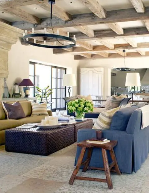 Farmhouse interiors often feature exposed wooden beams like this living room. The cool thing about them that they make any space captivating, cozy and special.