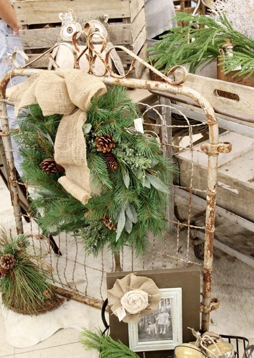 a shabby chic wire net with a fir wreath with pinecones and a burlap bow is a pretty vintage decoration for indoors and outdoors