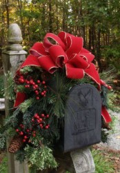 decorate your mail box with a red bow, fir branches, berries and pinecones for a cozy rustic outdoor feel