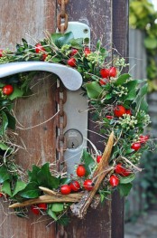 a greenery wreath with antlers, berries, twigs is a bright and chic natural touch to your outdoors and will bring some color