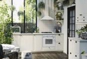 Completely White Kitchen With Lots Of Greenery